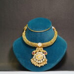 Gold toned with flower detailing prominent necklace