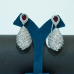 Silver toned & red stone drop earrings